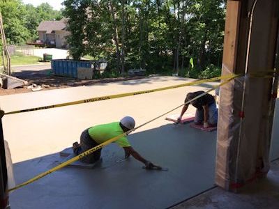 Pouring and smoothing concrete for new home construction