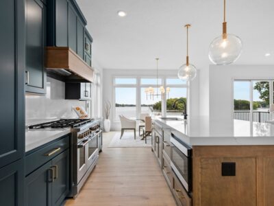 Custom kitchen with dark painted cabinets and large island