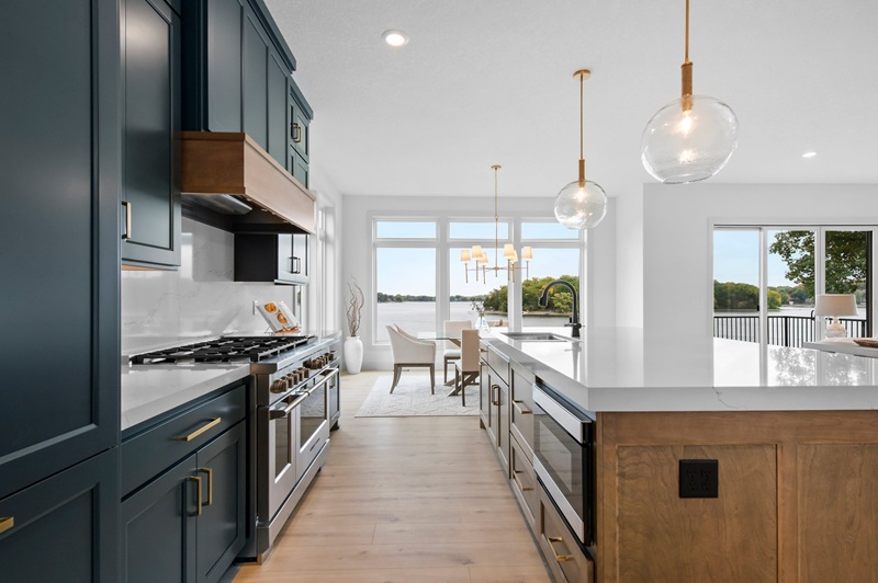 Custom kitchen with dark painted cabinets and large island
