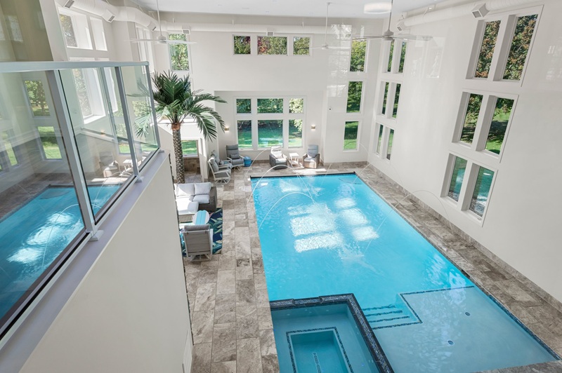 Custom indoor pool with seating area and large windows