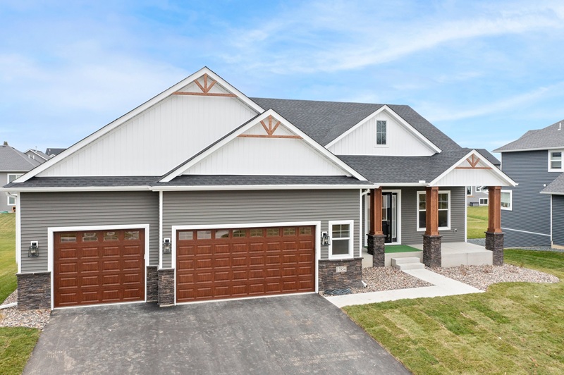 White and grey home exterior with wood accents