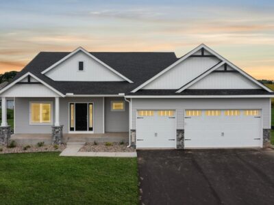 White with black accent home and 3-car garage